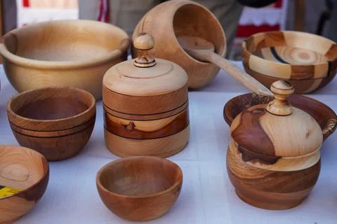 Kitchen utensils made of multi-colored wood on the table with a white table.. 스톡 사진