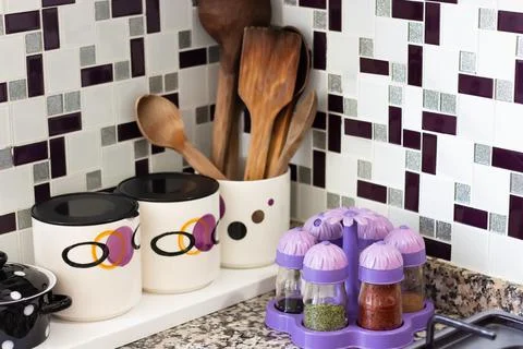 Kitchen utensils, spice jars, storage containers on kitchen countertops Stock Photos