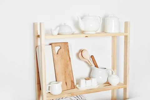 Kitchen utensils, tools, chef accessories and dishware on wooden shelf. Kitch Stock Photos