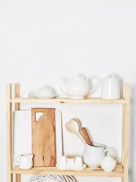 Kitchen utensils, tools, chef accessories and dishware on wooden shelf. Kitch Stock Photos