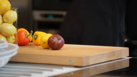 Kitchen view with vegetables and people moving. Stock Footage 106077541