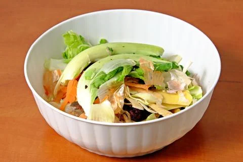 Kitchen waste fruit and vegetable scraps in a white plastic bowl cabbage carr Stock Photos