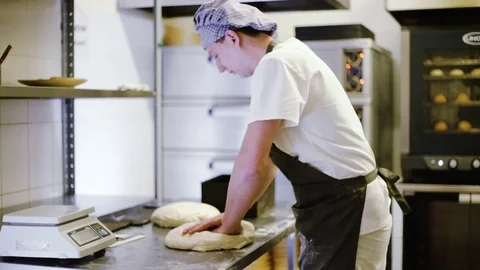 Kitchen worker prepares the dough for bread Stock Footage 69937213