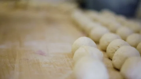 Kitchen worker prepares the dough for buns Stock Footage 69778961