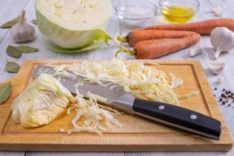 Kitchen workspace with the process of shredding white cabbage Stock Photos