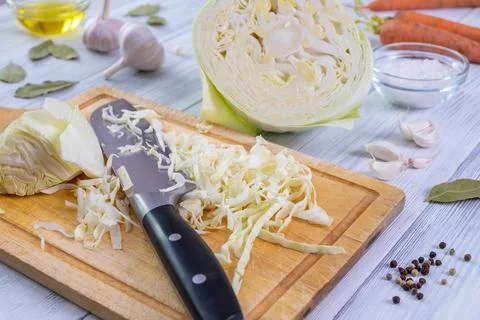 Kitchen workspace with the process of shredding white cabbage Stock Photos