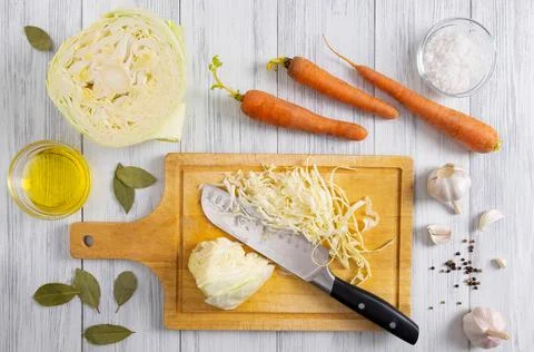 Kitchen workspace with white cabbage shredding process Stock Photos