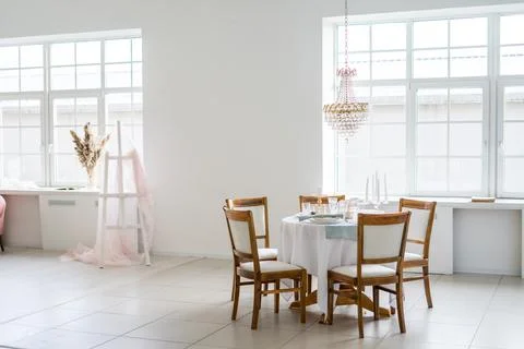 Kitchenette with white, round table and four chairs Stock Photos