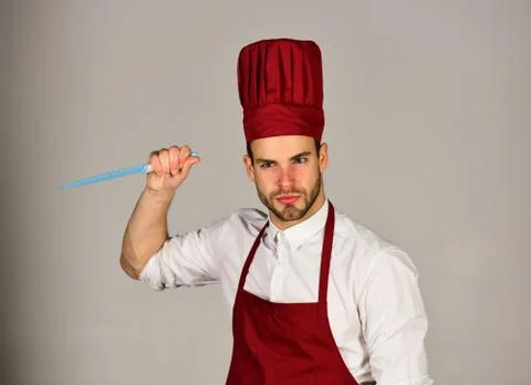 Kitchenware and cooking concept. Chef with strict face Stock Photos