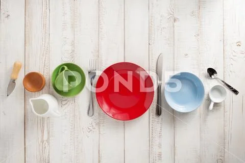 Kitchenware and crockery at wooden background Stock Photos