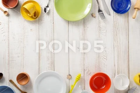 Kitchenware and crockery at wooden background Stock Photos