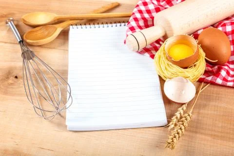 Kitchenware, egg and notebook for recipes on a wooden Stock Photos