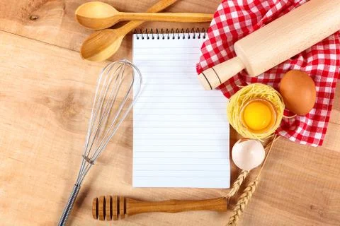 Kitchenware, egg and notebook for recipes on a wooden Stock Photos