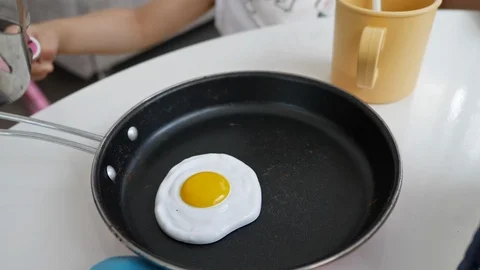 Kitchenware toy with fried egg in pan Stock Footage 96004057