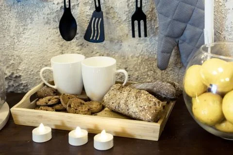 Kitchenware. Two white coffee mugs on a table in front of a concrete wall. Mu Stock Photos
