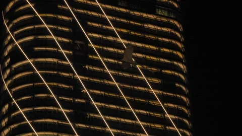 Kite Bird Flying Past Illuminated ITC Ratnadipa Twin Towers at Night Video stock 334843004