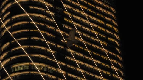 Kite Bird Flying Past Illuminated ITC Ratnadipa Twin Towers at Night Video stock 334843292