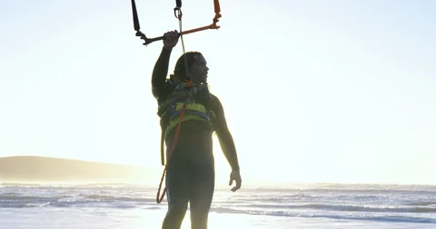 Kite boarder on the beach at sunset. 스톡 동영상 88373610