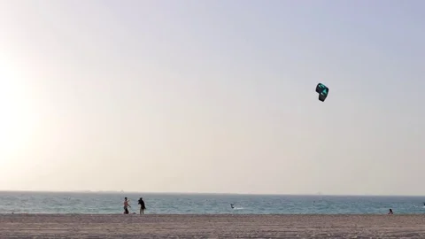 Kite-boarder jumps on the beach Stock Footage 76184629