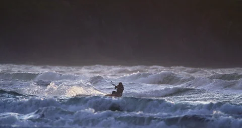 Kite boarder riding the waves at sunset. Stock Footage 88373604