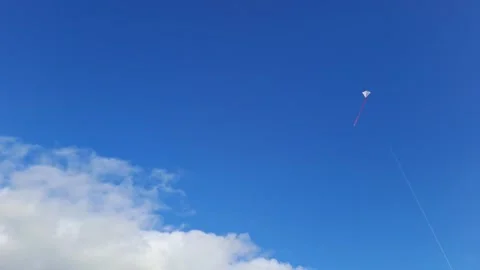 Kite Flying Against Blue Sky With Clouds On A Sunny Day UHD Stock Footage 265158889