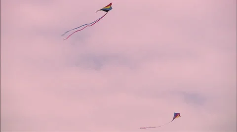 Kite flying against mostly cloudy skies Stock Footage 53336005