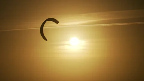 Kite flying high at sun during sunset Stock Footage 261705487