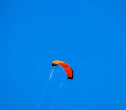 A kite is flying in the sky with a blue background Stock Photos