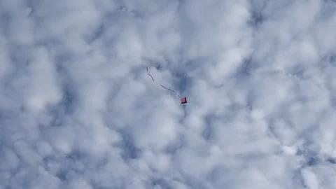 A kite flying under white clouds on a sunny day in Beijing Stock Footage 94642188