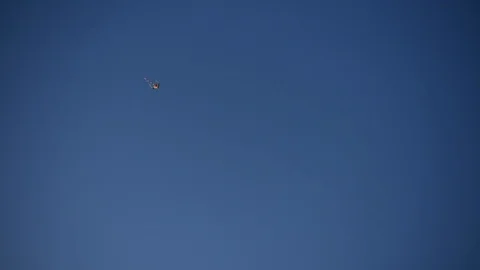 Kite hovers in the sky and on the background of the plain Stock Footage 119600054