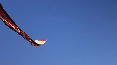 A kite is moving in the wind on a blue sky background Stock Footage 157996915