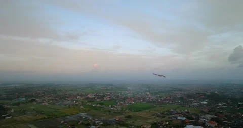 Kite soaring in the evening sky, among clouds at sunset Stock Footage 274626028