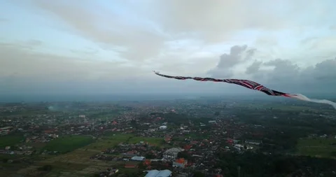 Kite soaring in the evening sky, among clouds at sunset Stock Footage 274956367