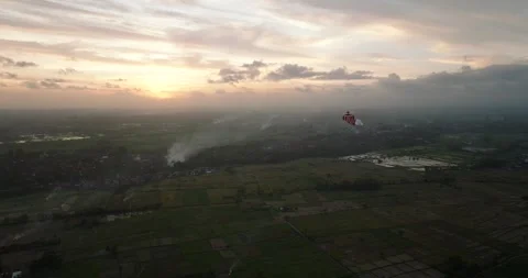 Kite soaring in the evening sky, among clouds at sunset Stockbeeldmateriaal 276318113