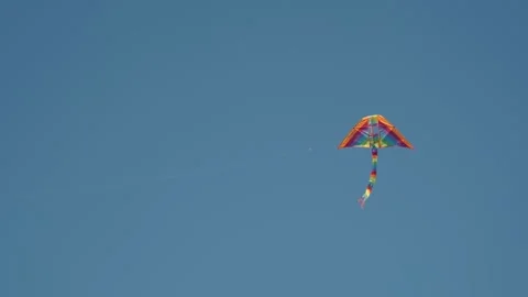 A kite soars through the blue sky Stock Footage 301389915