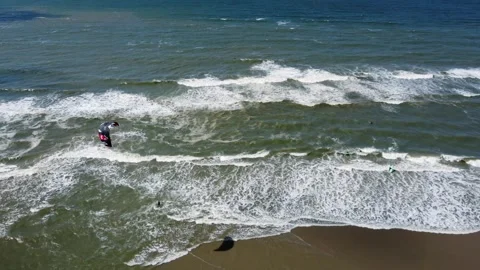 Kite surfer being pulled along on the surface of the sea by parachute Stockbeeldmateriaal 247989140