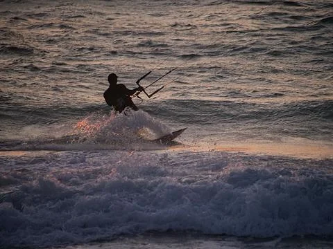 Kite surfer at dusk Stock Photos
