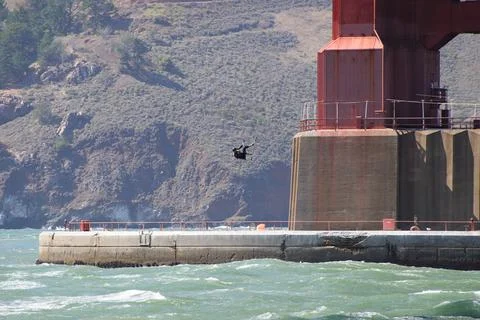 Kite surfer elevated by the wind under the Golden Gate Bridge Stock Photos