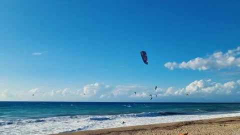 Kite surfer getting into the waves on Lefkada beach on a sunny and windy Stock Footage 291278934