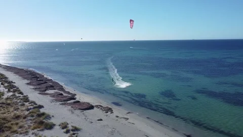 Kite surfer gliding along the sandy coastline aerial view Stock Footage 330977228