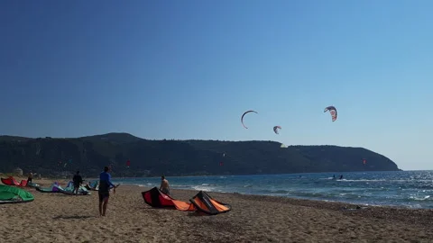 A kite surfer helping another to retrieve a kite after surfing. Stock Footage 244925653