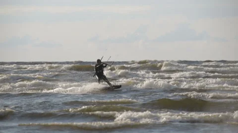 Kite Surfer in medium Waves passing by, 50 FPS Slow Motion Video stock 36034449