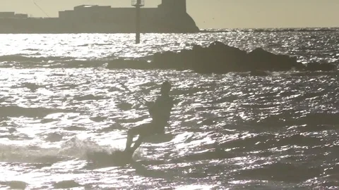 Kite surfer performing acrobatic stunt while wakeboarding in sea Stock Footage