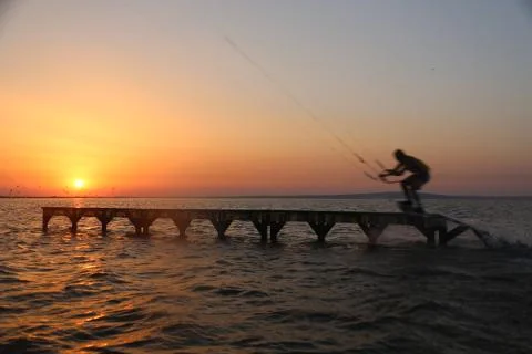 Kite surfer performs a trick Stock Photos