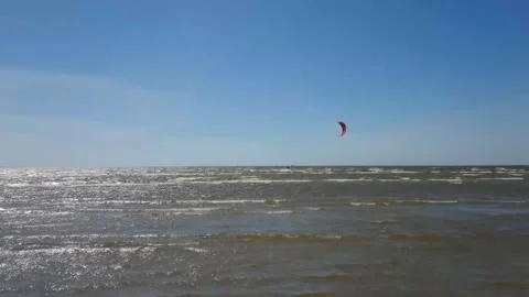 Kite surfer riding the waves Stock Footage 143903569