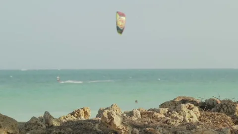 Kite surfers cross the frame, soft focus. Stock Footage 82328131