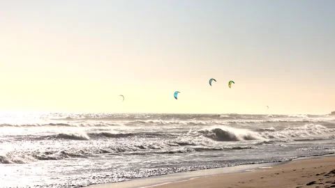 Kite surfers enjoy the wind at the beach Видео 340558176