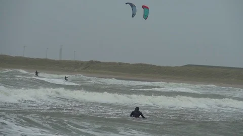 Kite surfers out on stormy beach Stock Footage 72486830