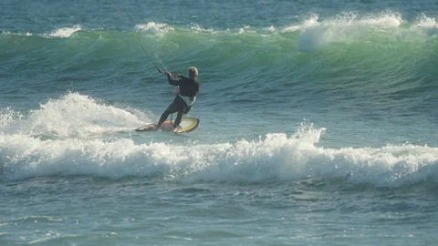 Kite surfing over a wave in slow-motion Stock Footage 88284806