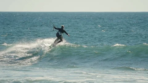 Kite surfing in slow-motion over a wave Stock Footage 88284301